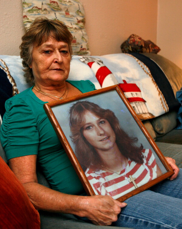 Jan Miller holds a photo of her daughter, Laura Miller, who was killed and her body found in a League City field in 1986, Oct. 18, 2011, in Texas City, Texas. (Jennifer Reynolds/The Galveston County Daily News via AP, File)