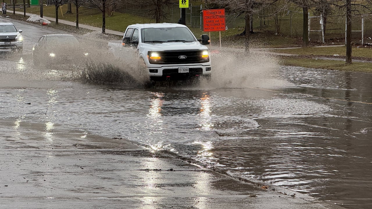 Car goes through massive puddle. 