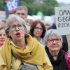 A sign reading "Grannies against the right" shows a demonstrator among several thousand people protesting against right-wing extremism and racism on the grounds of the Deutzer Werft shipyard on June 1.