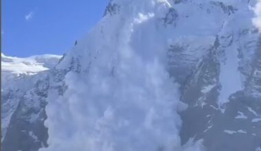 An avalanche falls down a cliff.