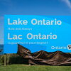Ontario Premier Doug Ford, right, and Niagara West Member of Provincial Parliament Sam Oosterhoff unveil a sign for Lake Ontario at the Fifty Point Conservation Area in Grimsby, Ontario, Canada, on Saturday, Aug. 29, 2026.