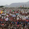 Yemeni supporters of the Houthi movement gather during a rally in Sanaa, Yemen, on July 17. Many people standing in the large crowd are holding up signs.