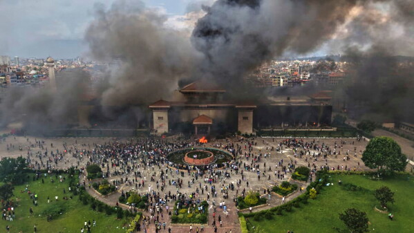 Protesters celebrate at the parliament building after it was set on fire during a protest against social media ban and corruption in Kathmandu, Nepal, on Sept. 9, 2025. (AP Photo/Prakash Timalsina, File)