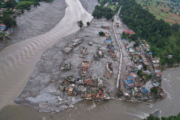 A drone view of the aftermath of flash flooding at the confluence of the Trishuli and Tadi rivers in the Devighat area of Nuwakot district, Nepal, Saturday, Aug. 29, 2026. (AP Photo/Rajesh Kumar Singh)