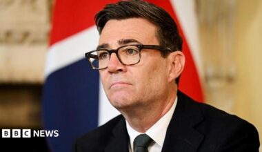 Andy Burnham sitting in front of a Union Flag in Downing Street