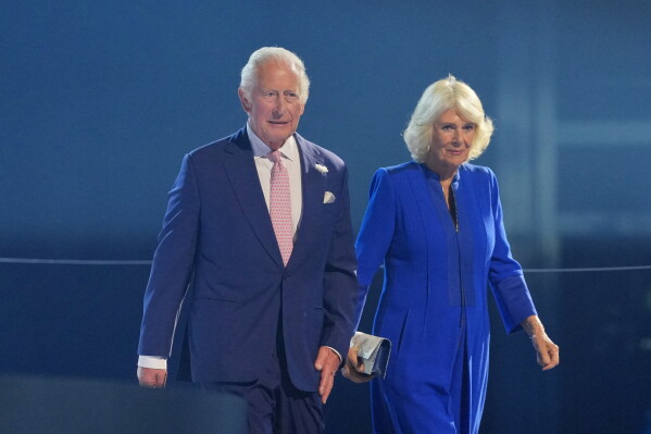 Britain's King Charles and Queen Camilla arrive for the Commonwealth Games opening ceremony in Glasgow, Scotland, July 23, 2026. (AP Photo/Kin Cheung, File)