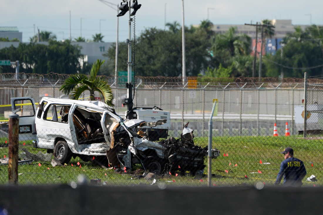 An NTSB investigator works near a damaged van at the site where an Amazon cargo plane overshot the runway two days earlier while landing at Miami International Airport, Tuesday, Sept. 8, 2026, in Miami.