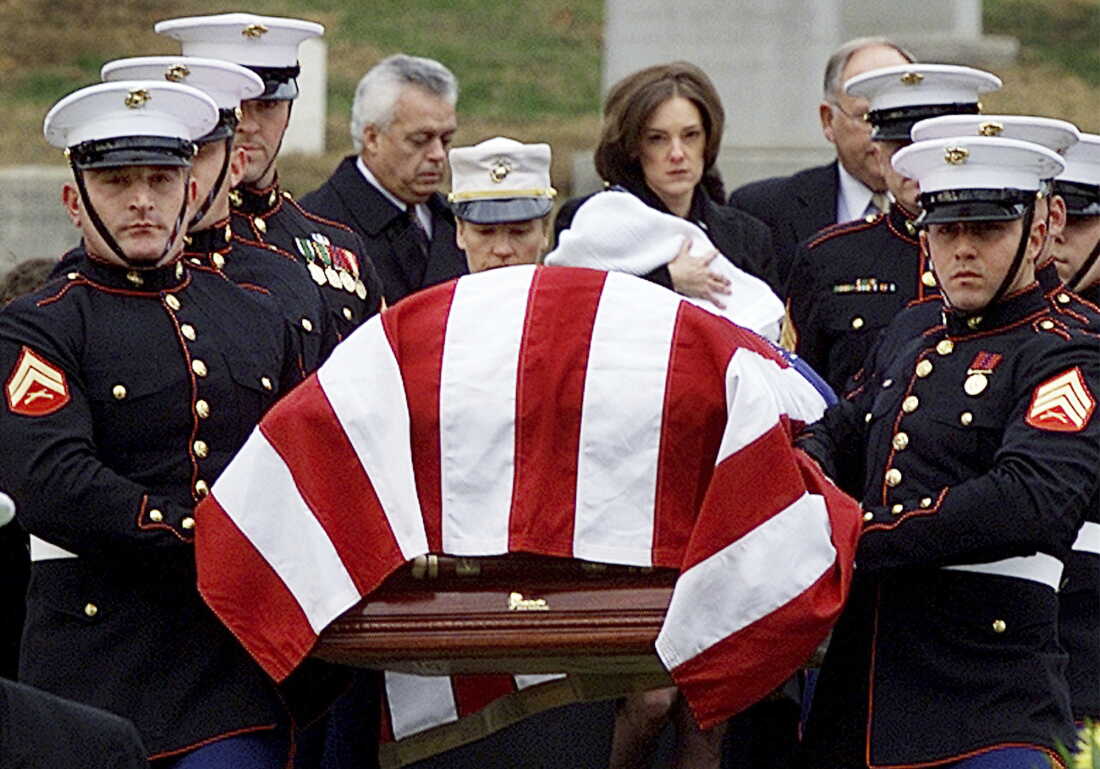 CIA officer Johnny Michael Spann, 32, was the first American killed in Afghanistan after the Sept. 11, 2001, attacks in the U.S. Spann's widow, Shannon Spann, and their 6-month-old son Jake follow Spann's casket to the grave site at Arlington National Cemetery on Dec. 10, 2001. The CIA's paramilitary force grew substantially as the agency joined the fight in Afghanistan after the 9/11 attacks.