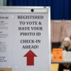 A sign informs registered voters to have their photo IDs ready to check in at a polling place in Lancaster, N.H., in 2024.