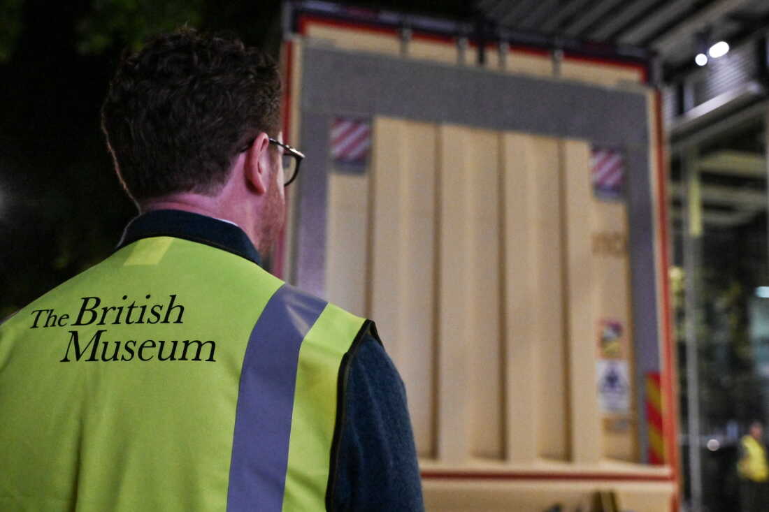 Nicholas Cullinan, director of the British Museum, waits for the truck (behind) carrying the Bayeux Tapestry to be unloaded at the museum in central London early on July 10, 2026, after a complicated journey to leave France for the first time in more than 900 years for an exhibition in the British capital.
