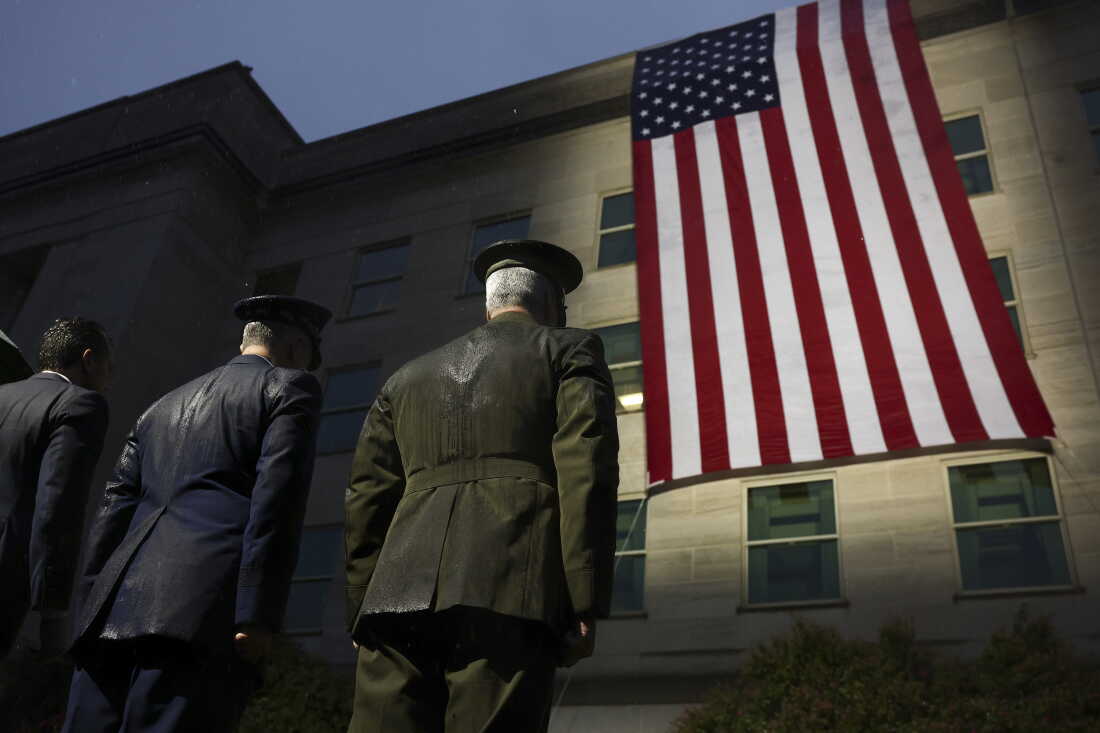 Members of the military and first responders watch as an American flag is unfurled on the side of the Pentagon to mark the 25th anniversary of the September 11th terrorist attacks on September 11, 2026 in Arlington, Va.