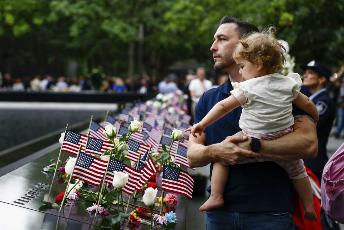 Matt Dunleavy and his daughter Ellie Dunleavy take part in a ceremony commemorating the 25th anniversary of the Sept. 11, 2001, attacks at the National September 11 Memorial in New York City on Friday.