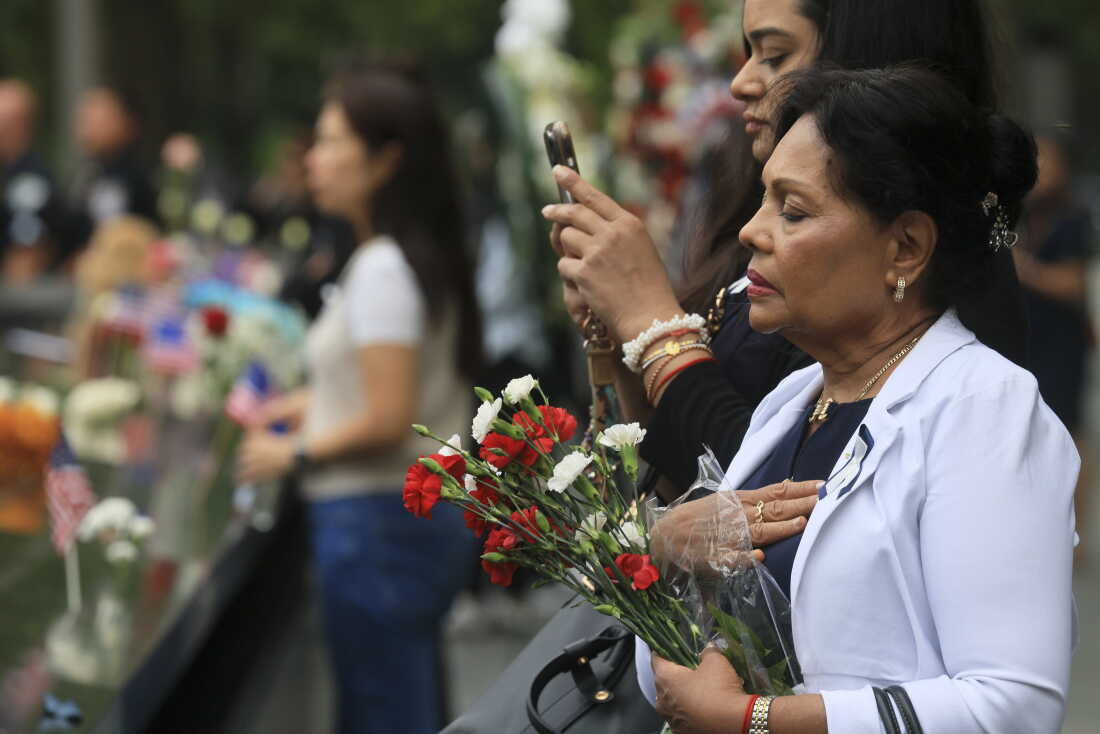 People pause at the memorial during a ceremony commemorating the 25th anniversary of the Sept. 11, 2001, attacks at the National September 11 Memorial in New York City on Friday.