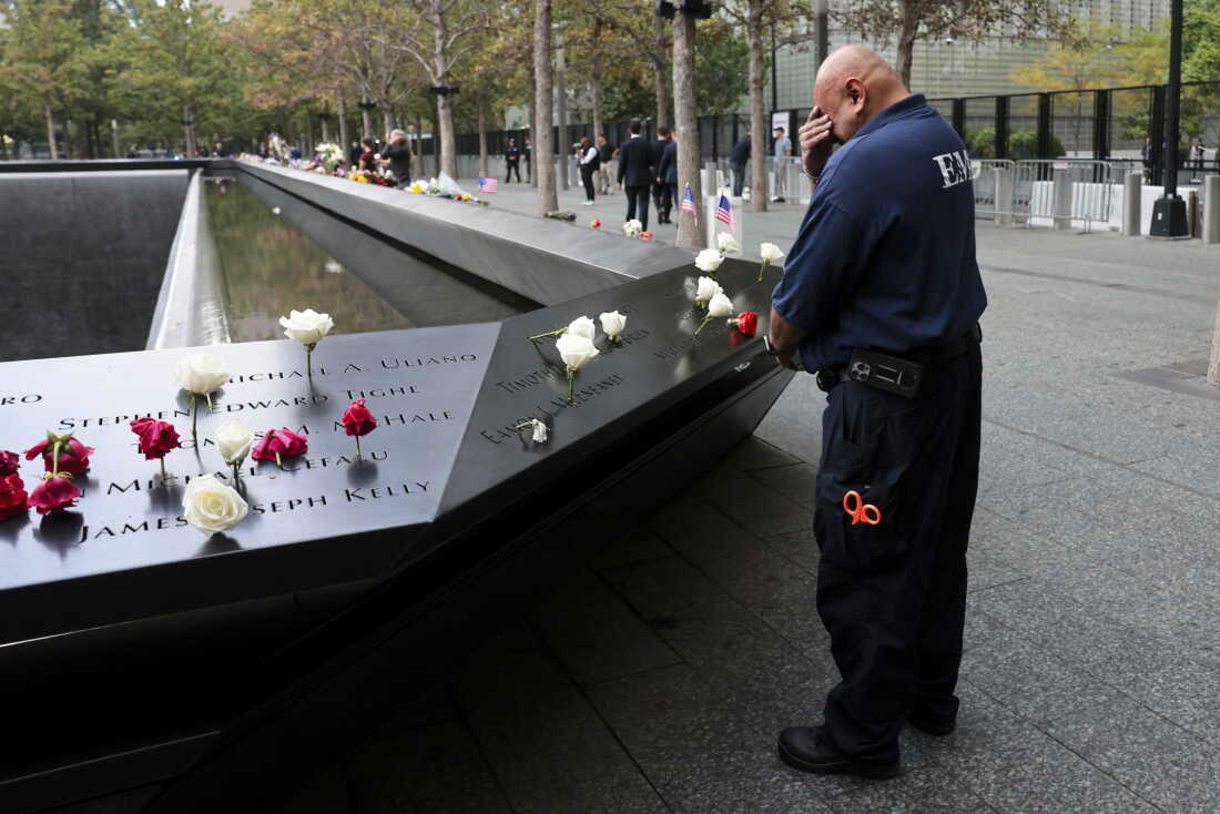 A first responder pauses at the memorial ahead of a ceremony commemorating the 25th anniversary of the September 11th terrorist attacks on the World Trade Center at the National 9/11 Memorial & Museum on Friday in New York City.