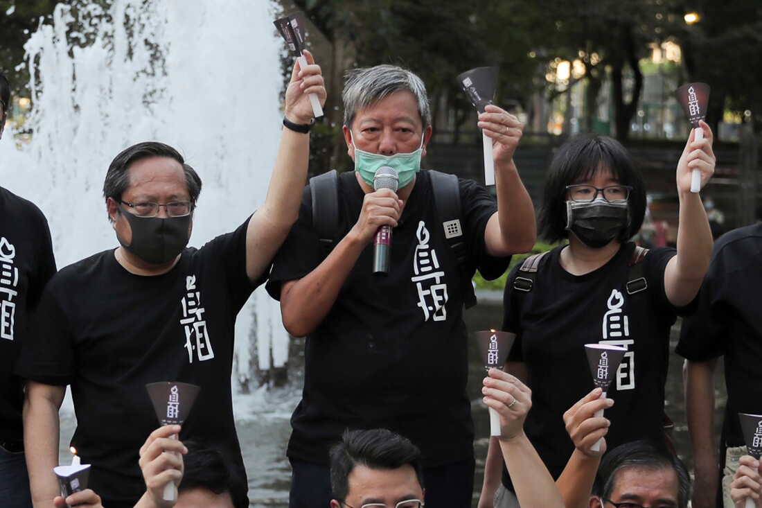 FILE - Pro-democracy activists including from left Albert Ho, Lee Cheuk-yan and Chow Hang-tung shout slogans during a gathering to mourn those killed in the 1989 Tiananmen crackdown at Victoria Park in Causeway Bay, Hong Kong on June 4, 2020.