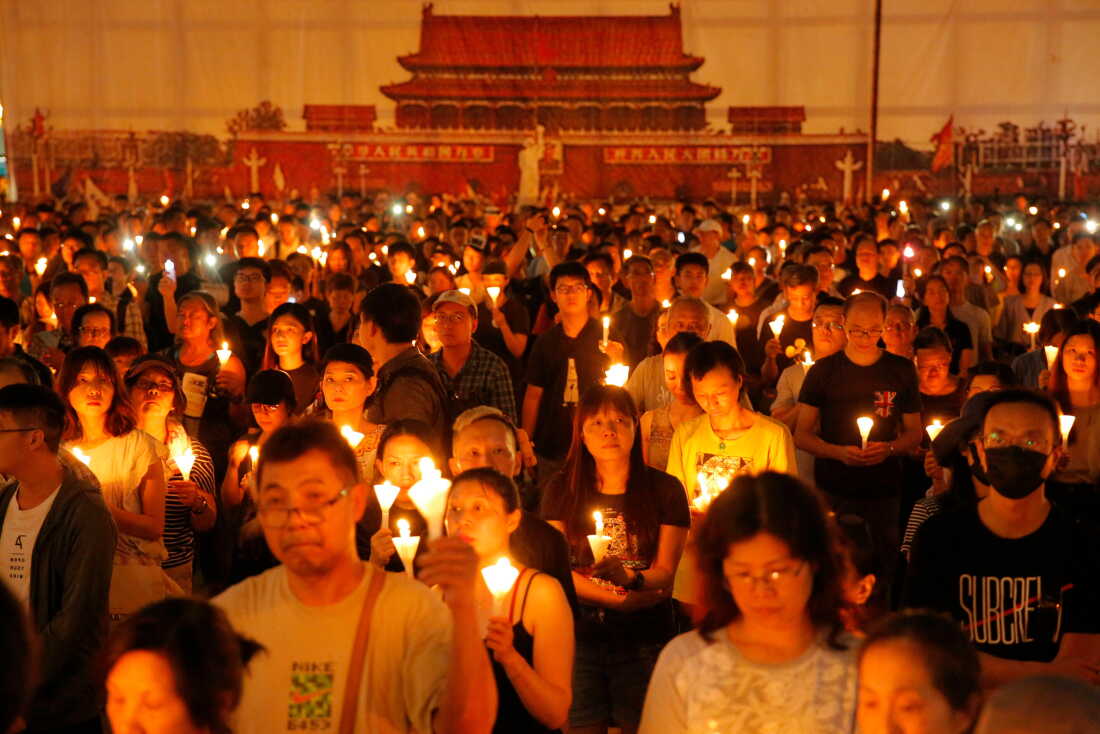 FILE - Thousands of people attend a candlelight vigil for victims of the Chinese government's brutal military crackdown three decades ago on protesters in Beijing's Tiananmen Square at Victoria Park in Hong Kong, June 4, 2019.