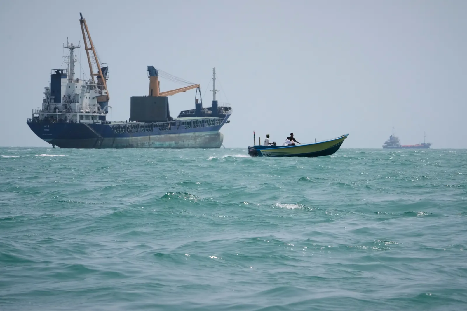 A motorboat passes a general cargo ship anchored in the Strait of Hormuz off Bandar Abbas, Iran, Sunday, Sept. 6, 2026. | AP Photo/Vahid Salemi