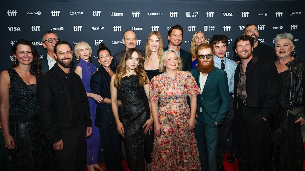 A large number of people pose together.