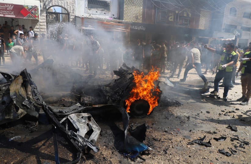 Residents attempt to extinguish a fire following an Israeli airstrike that hit a vehicle in Gaza City, August 31, 2026.