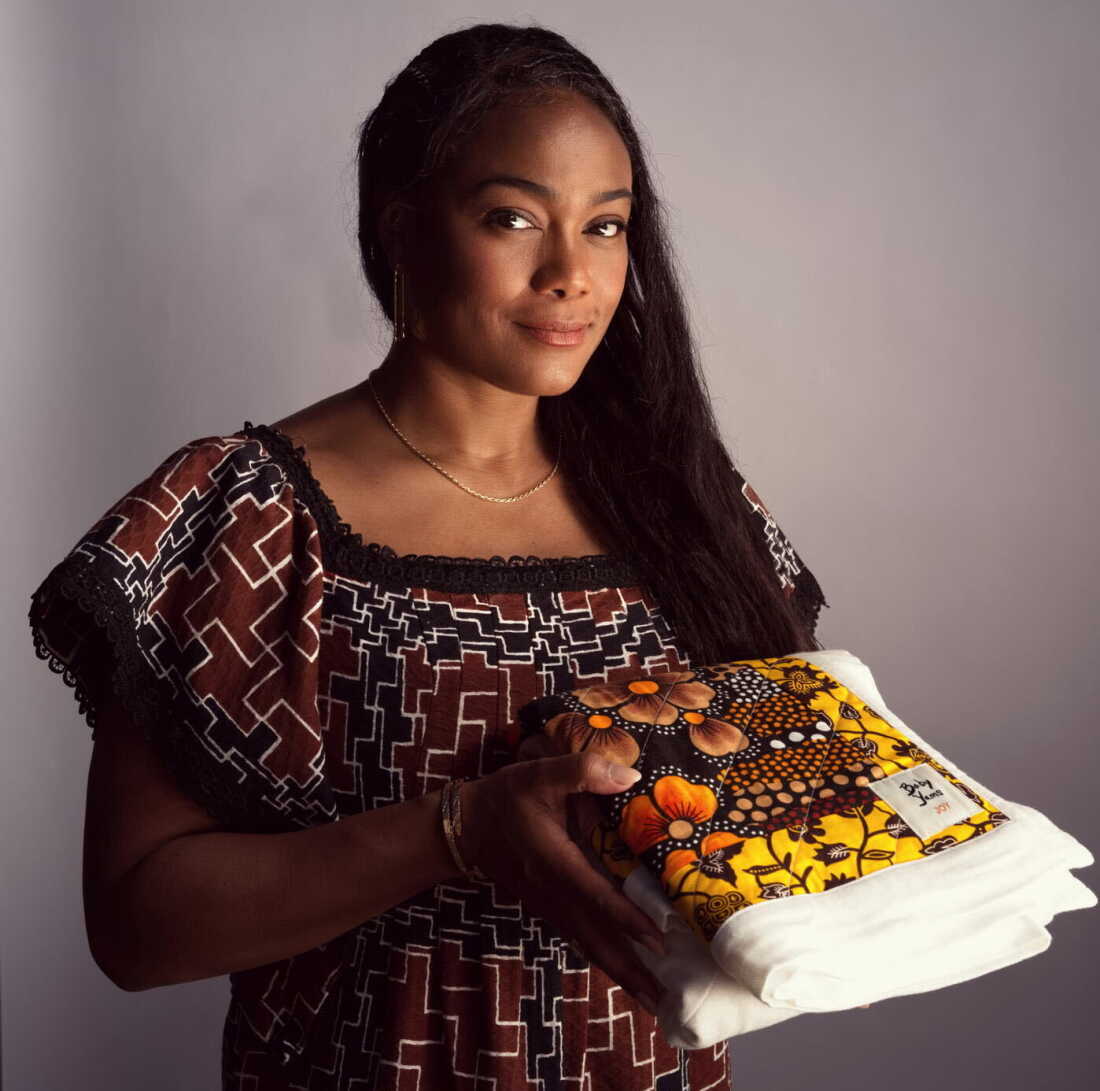 Actor Tatyana Ali holds a Baby Yams quilt. Ali’s baby blankets raise funds and awareness for Black and Indigenous birth workers.