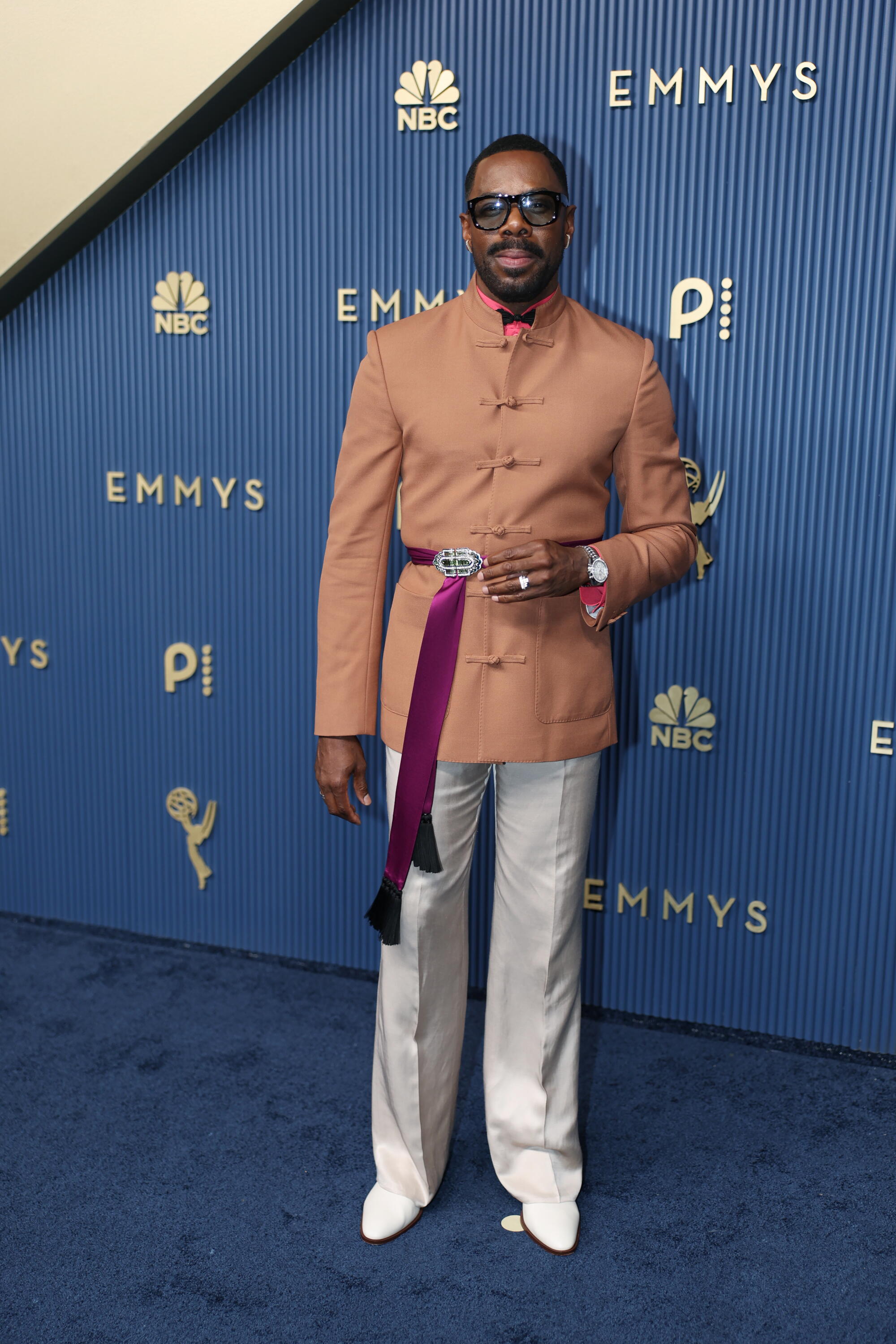 Colman Domingo poses on the Emmys blue carpet. 