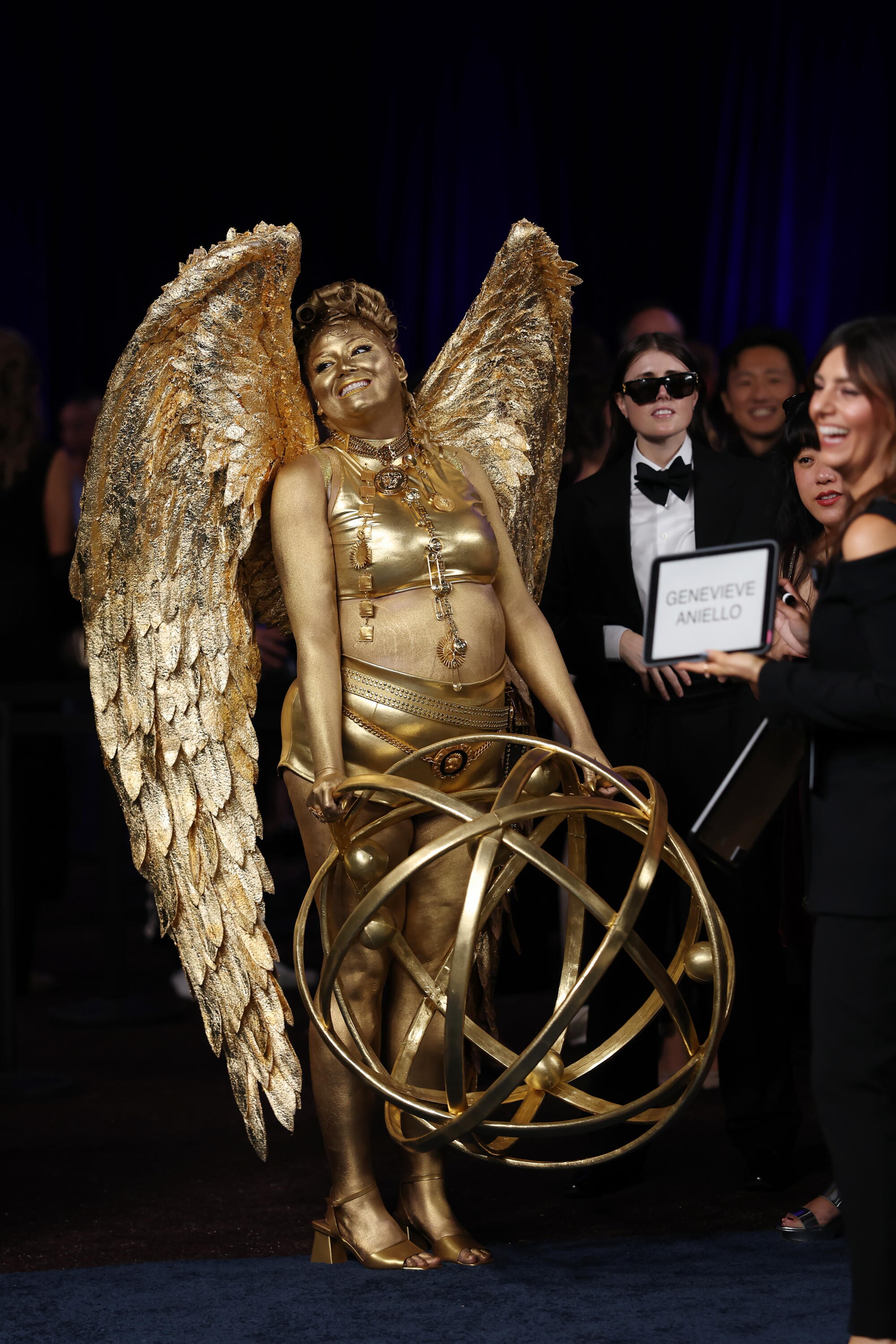 Megan Stalter, covered in gold paint, resembles an Emmy statue. 