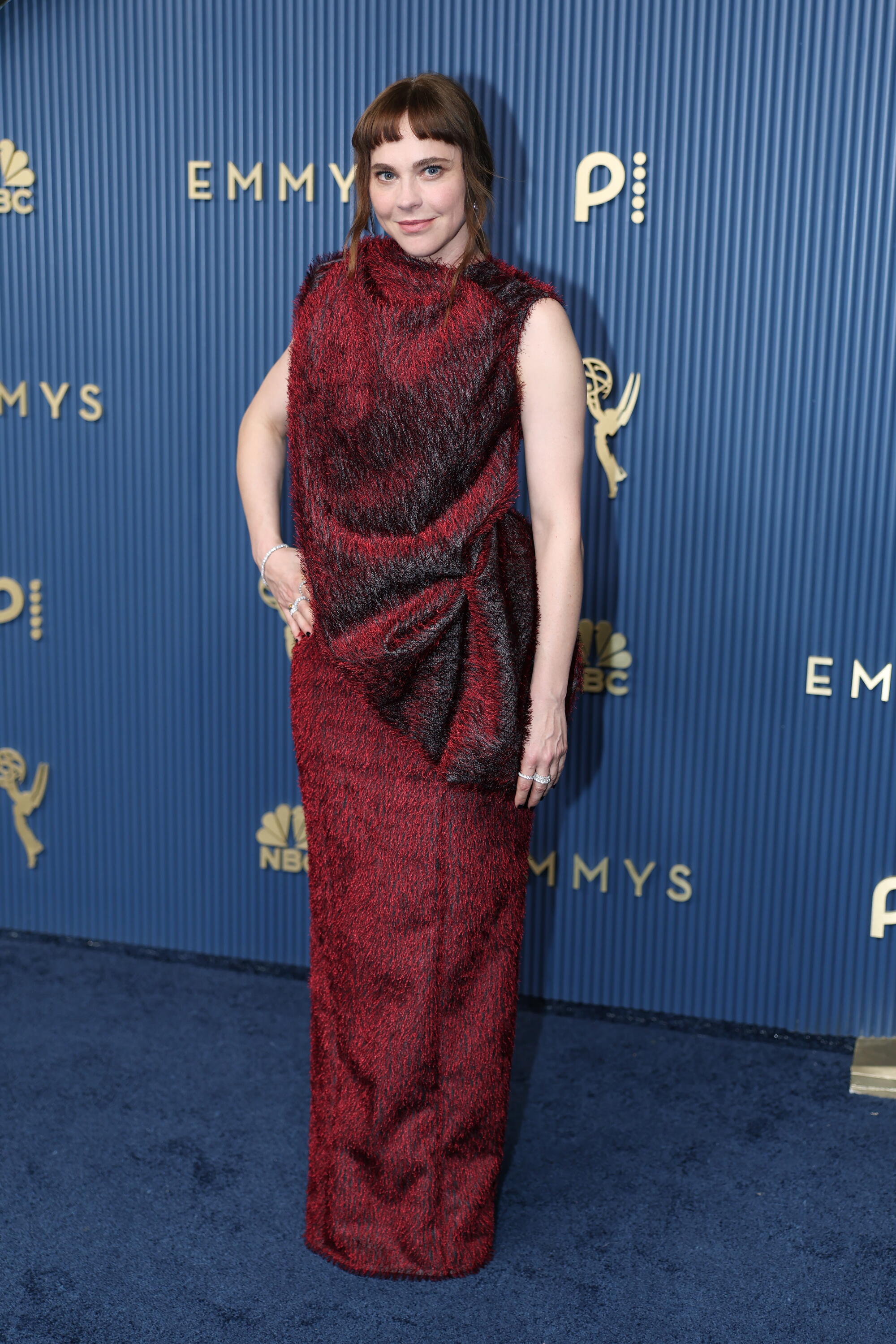 Fiona Dourif poses on the Emmys blue carpet. 