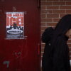 A poster calling on U.S. Immigration and Customs Enforcement (ICE) to get out of the community hangs on a door in the Little Village neighborhood on January 22, 2025 in Chicago, Illinois.