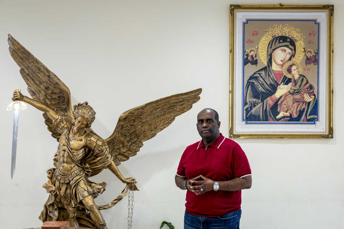Rev. Fr. Reginald Jean-Mary, pastor of Notre Dame d'Haiti Catholic Church, poses for a portrait in the Little Haiti neighborhood of Miami, Fla.