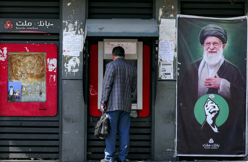 A man uses an automated teller machine (ATM) from Bank Mellat in Tehran on September 7, 2026. 