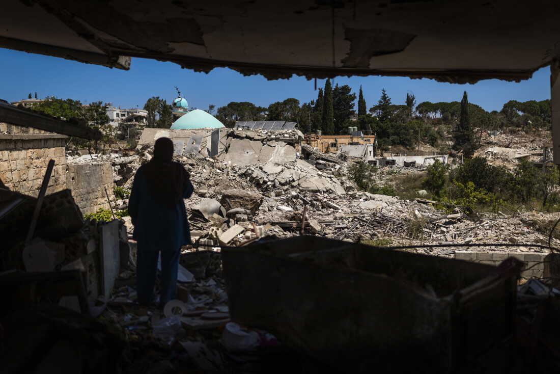 Mahasen Fakih stands outside her destroyed apartment in Zawtar al-Gharbiyah after returning to the village days earlier. The village is the first in a pilot project brokered by the U.S. for Israeli forces to withdraw and Lebanese forces to move in to secure the area.