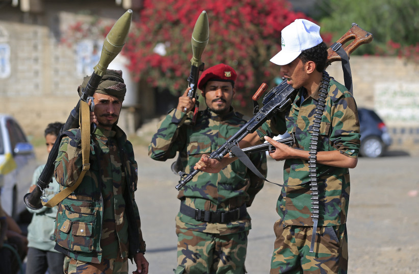 Fighters loyal to the Houthi authorities, brandish their weapons during a rally to recruit more fighters, in Sanaa on September 10, 2026.