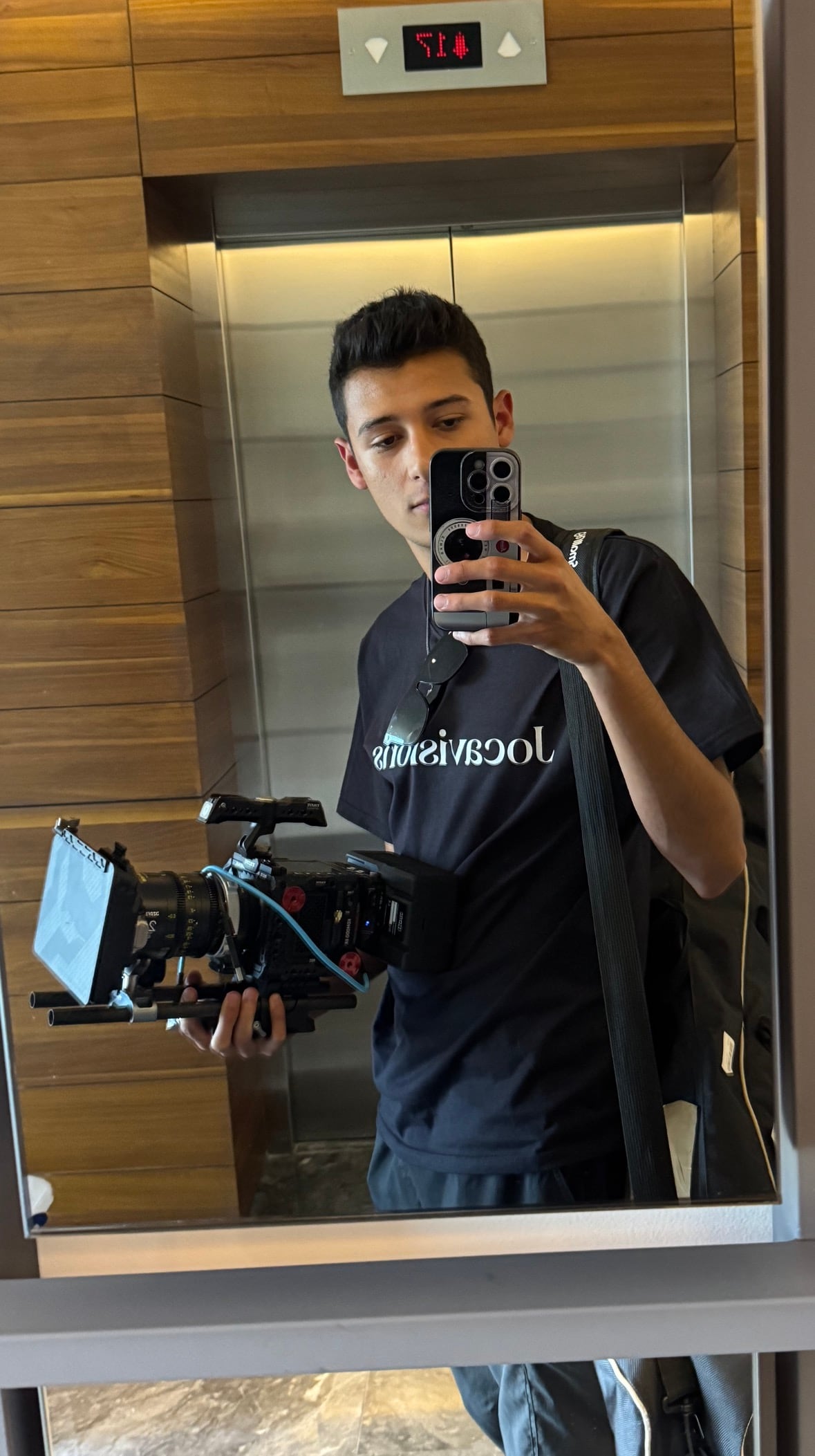 A man is pictured with a camera taking a selfie in a mirror.