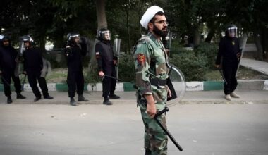 Iranian state-affiliated cleric wearing military gear and uniform during deployment to crack down on protesters