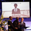 Elmore Wonsley, center, speaks next to attorney Ben Crump, left, and Rev. Al Sharpton during a memorial service for Nolan Xavier Wells on Monday.