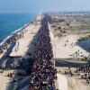 This aerial photo shows displaced Gazans walking toward Gaza City on Jan. 27, 2025, after crossing the Netzarim corridor from the southern Gaza Strip.