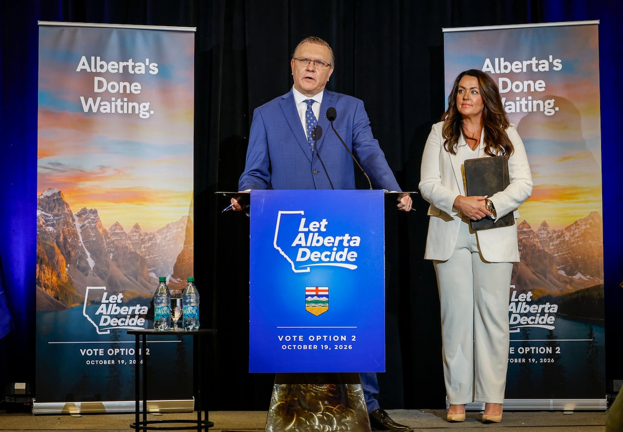 Two people stand behind a podium.