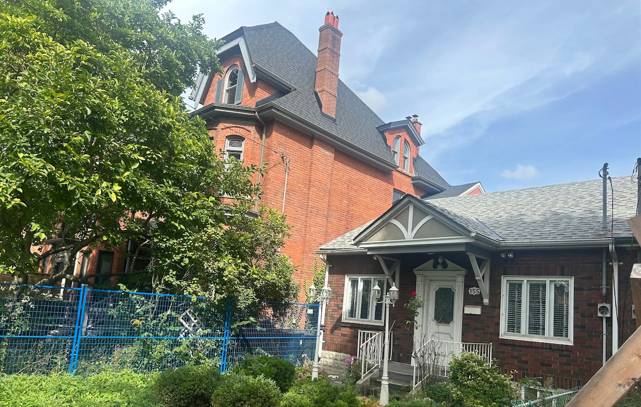 The Martins' home, on the left will be overshadowed when the cottage next door is replaced with a four-storey duplex whose walls will abut part of their house.