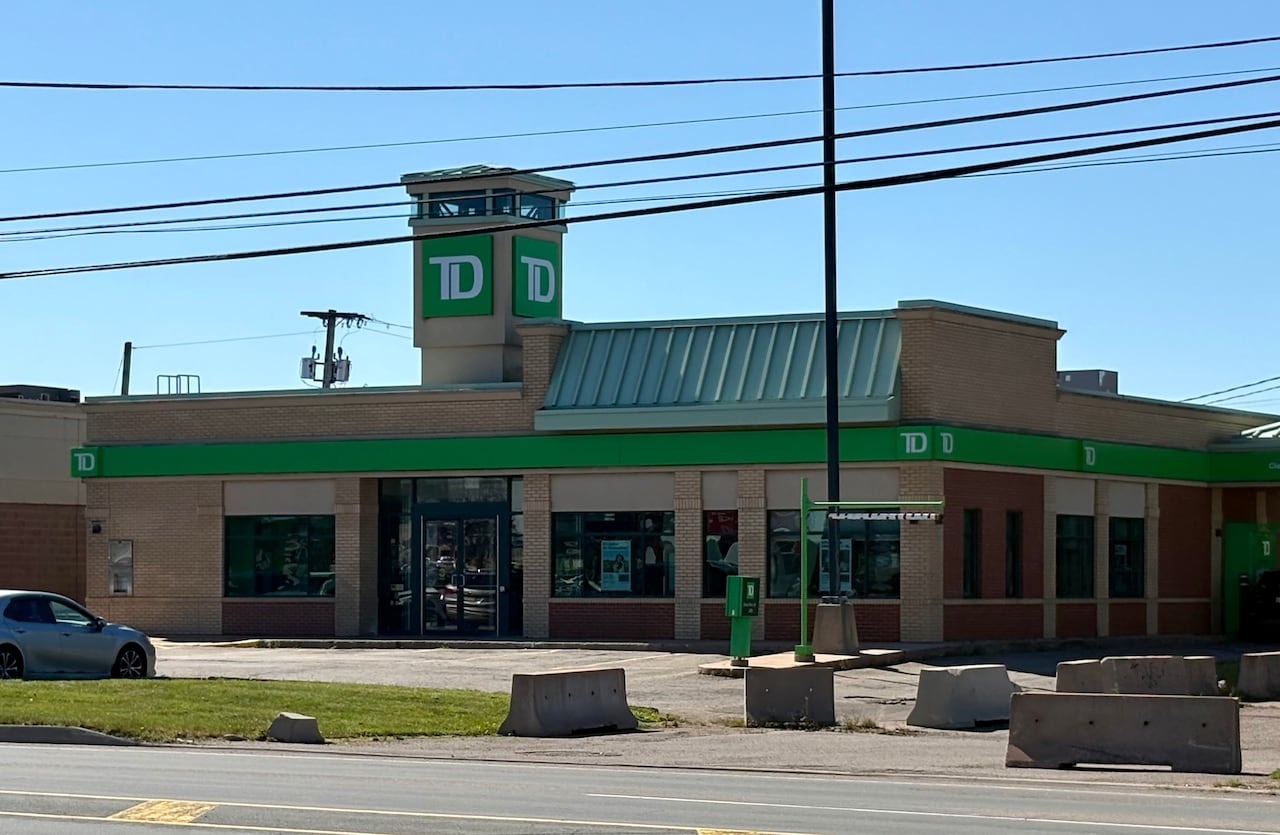 A TD Bank is seen from the outside with a car in the parking lot.
