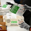 Election workers process mail-in ballots in Industry, Calif., in June.