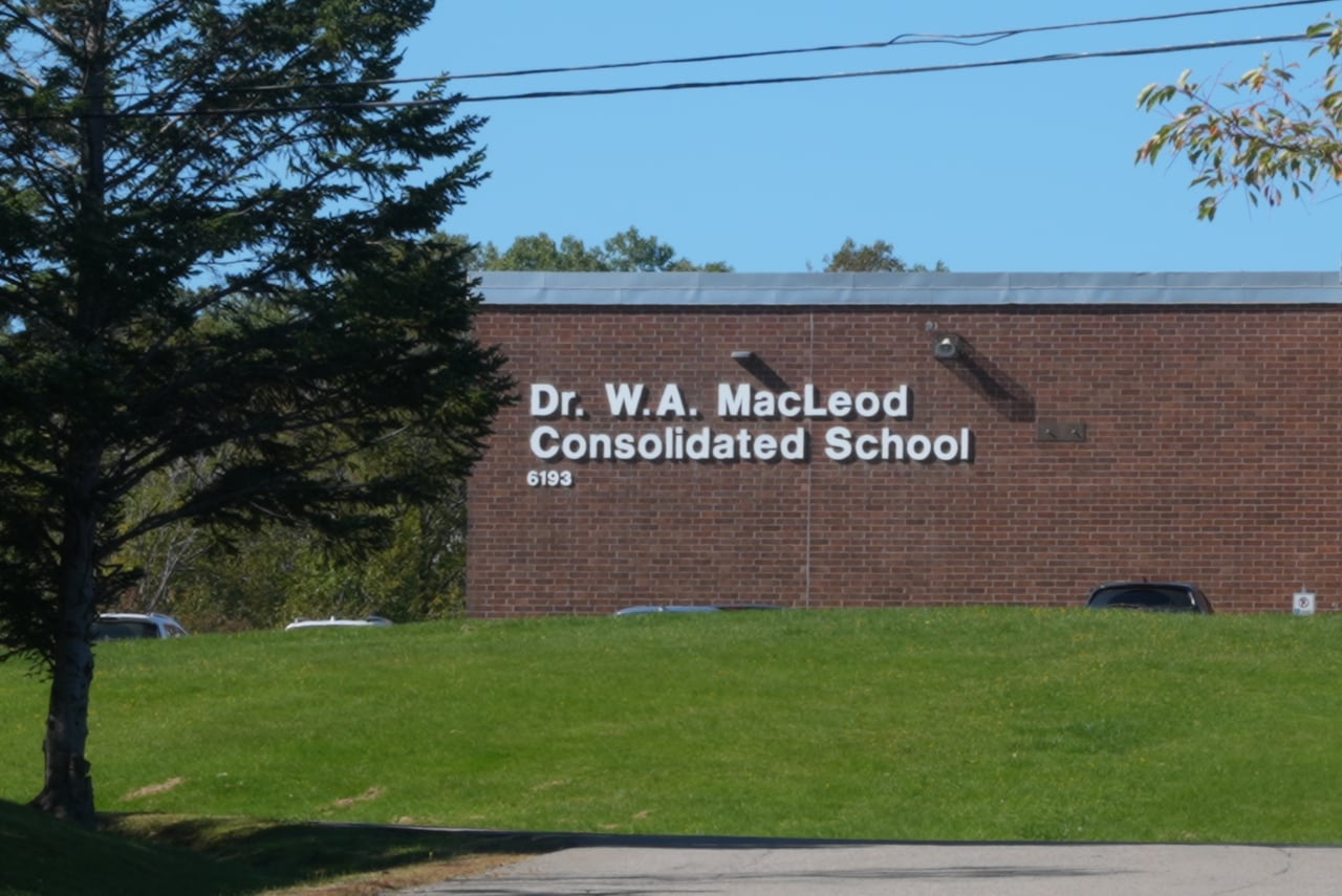 A brick building with the words Dr. W. A. MacLeod Consolidated School.