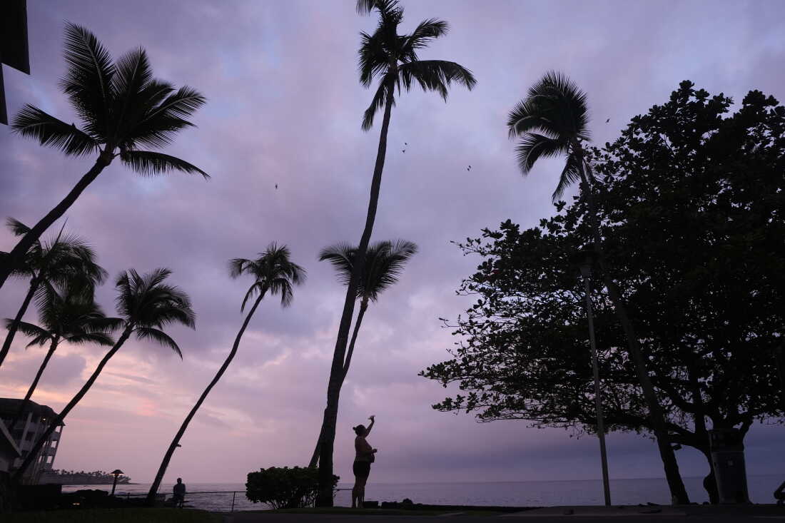 Ryanna Fry takes a picture of clouds as Hurricane Nolo sits nearby in Kona, Hawaii, Friday, Sept. 25, 2026