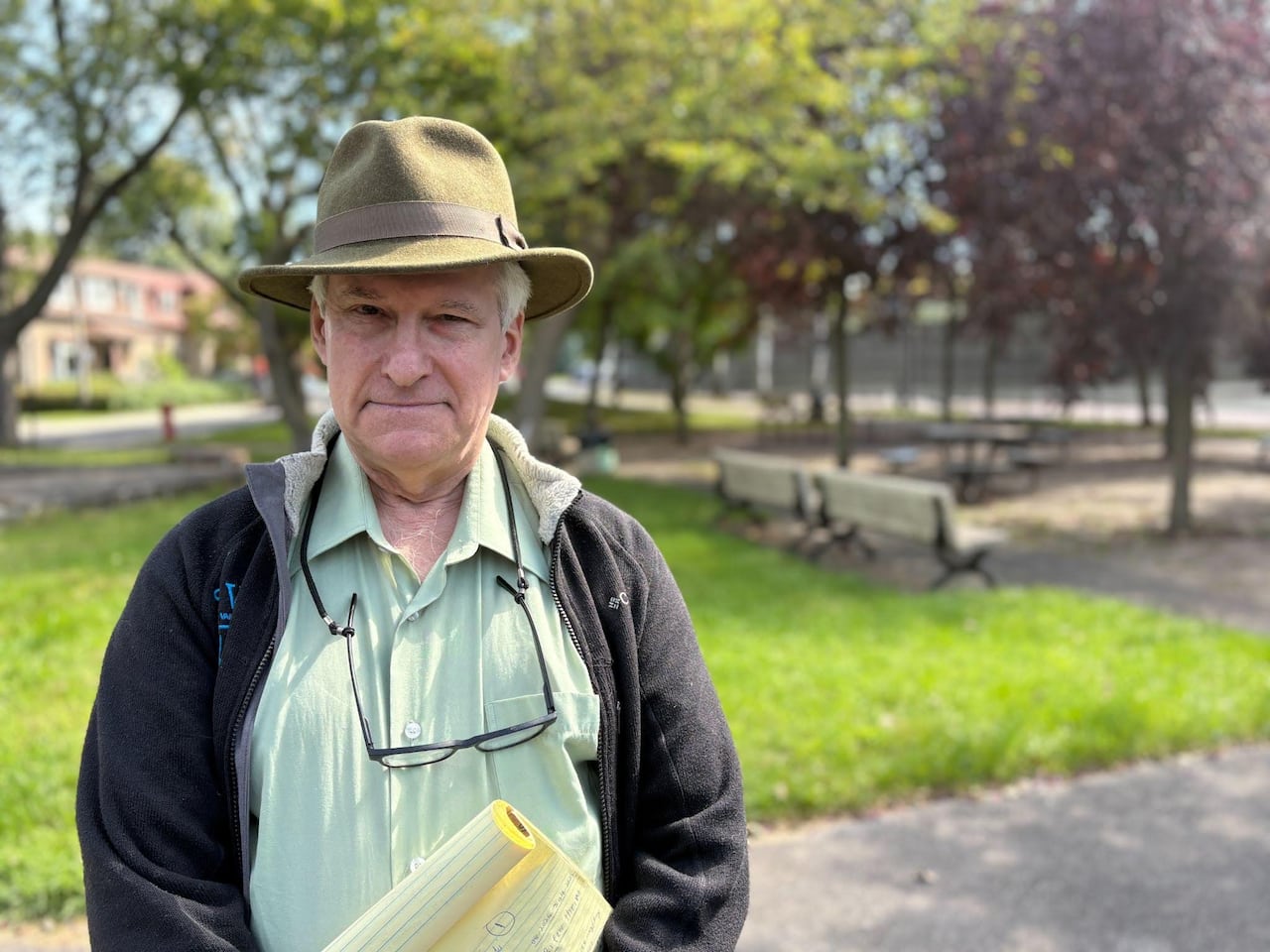 A man standing outside wearing a hat.