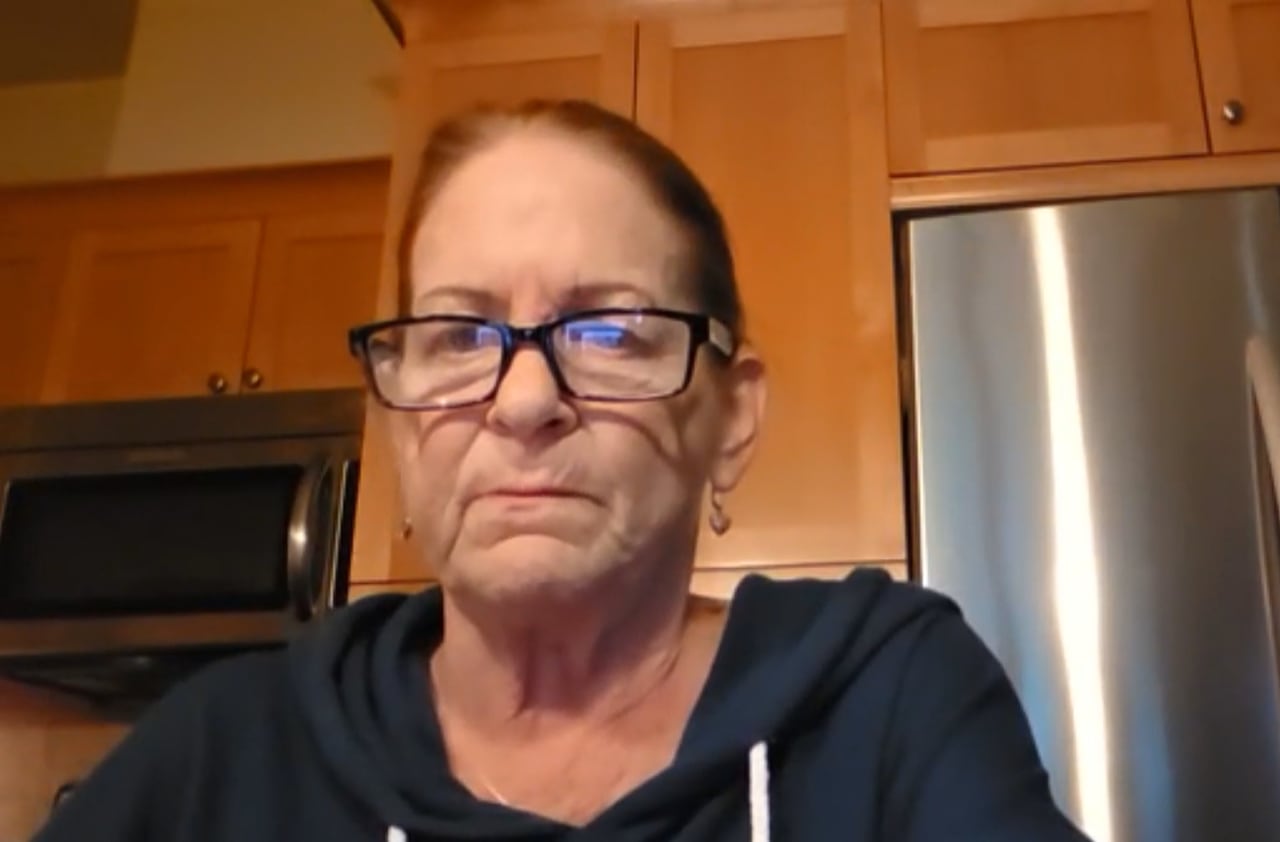 Paige Adamson is pictured in her home in Point Roberts, Washington. She is a white woman with black hair and glasses.