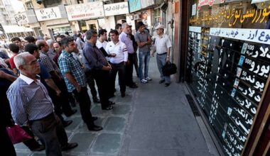 Crowds check dollar and euro rates at a Tehran currency exchange as Iran’s rial comes under pressure