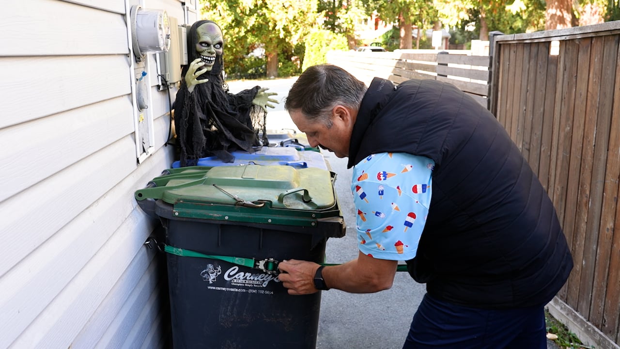 A man reinforcing a bin to his house