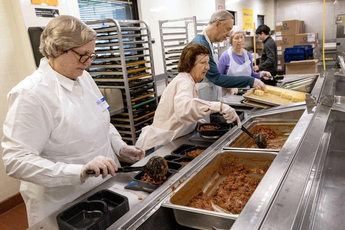 Volunteers prepare food at Community Servings, a Boston nonprofit that produces medically-tailored meals.