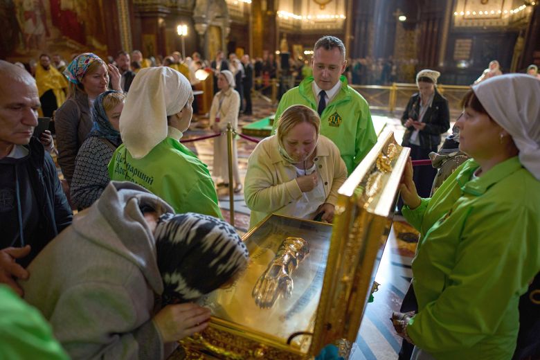 Russian Orthodox believers venerate the relics at Moscow's Cathedral of Christ the Saviour, where one of three reliquaries with the remains was displayed for public worship.