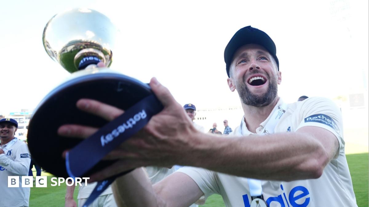 Warwickshire players lift the County Championship trophy