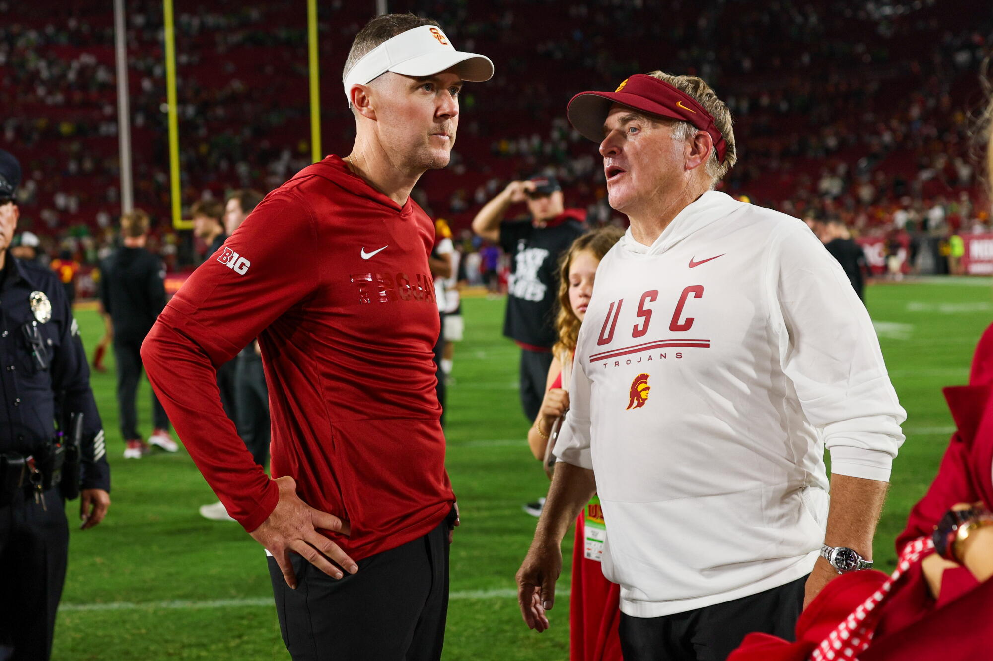 USC coach Lincoln Riley, left, and defensive coordinator Gary Patterson talk on the field.